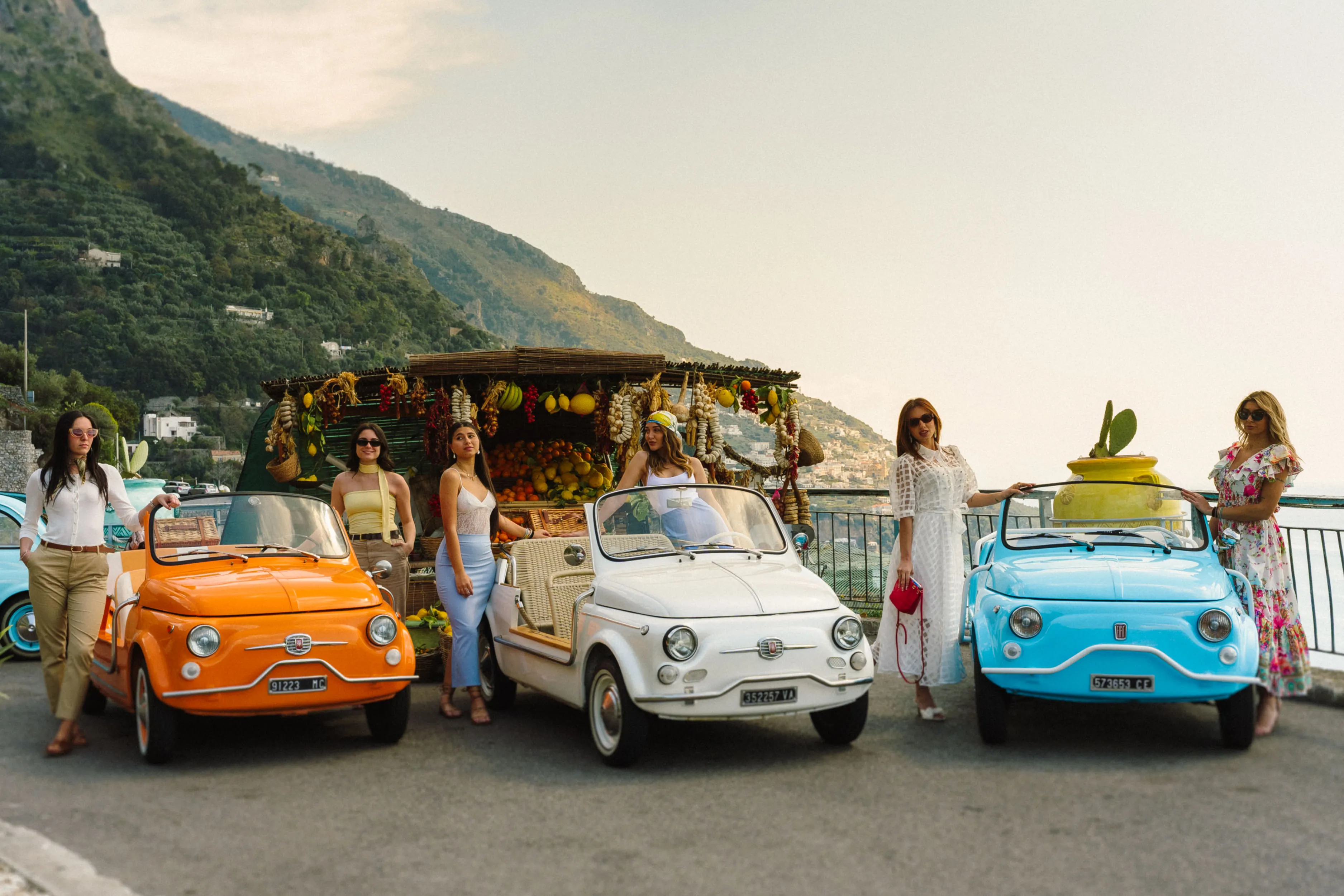 Group photo in the open-top Fiat 500 Jolly with Amalfi Coast backdrop