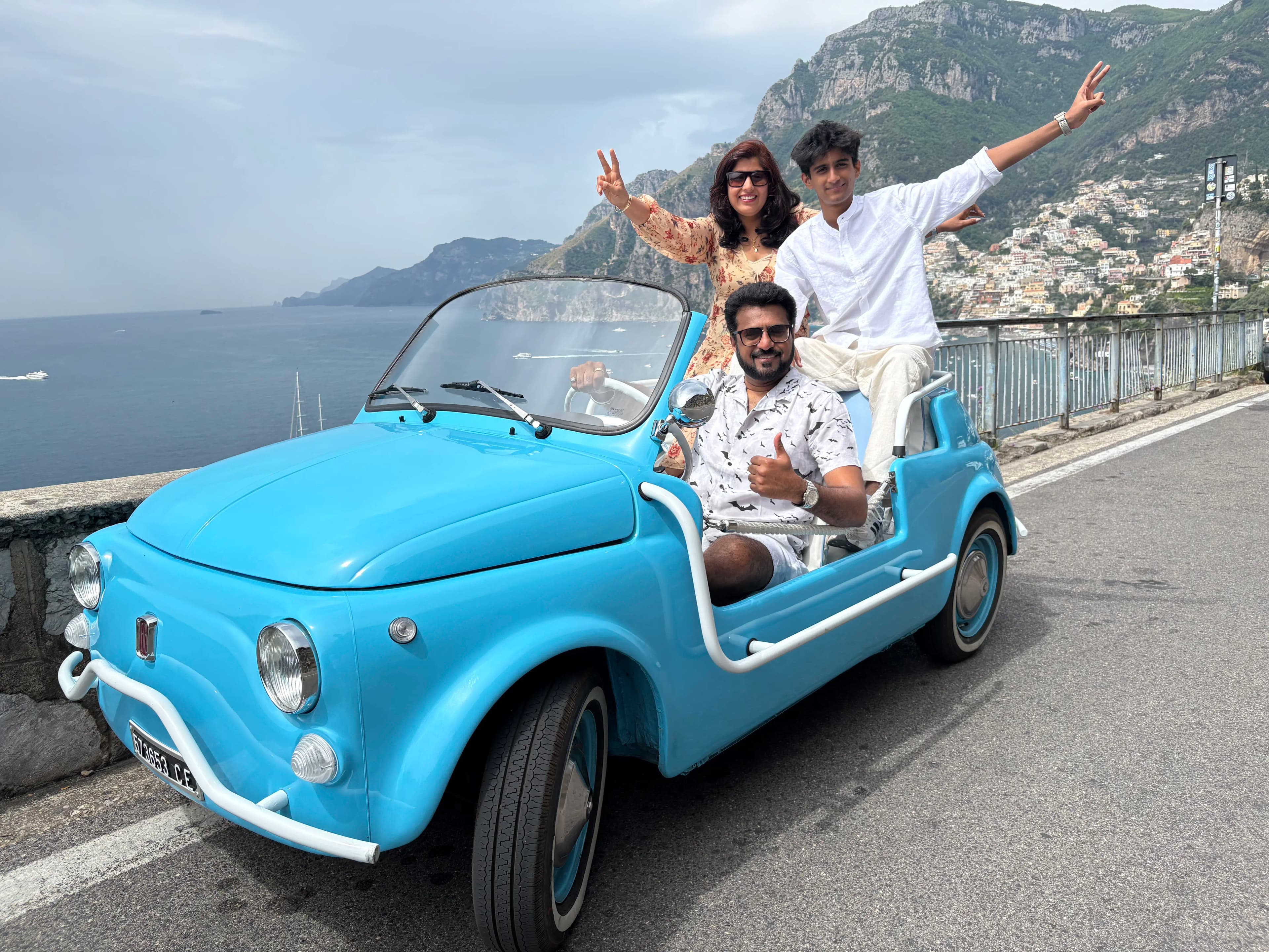 Group photo in the open-top Fiat 500 Jolly with Amalfi Coast backdrop